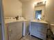 Bright laundry room with washer, dryer, and vanity at 53 W Marbrisa Way, Kissimmee, FL 34743