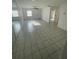 Bright living room featuring tile floors, ceiling fan, and sliding mirrored closet doors at 53 W Marbrisa Way, Kissimmee, FL 34743