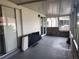 View of an empty screened in patio with sliding doors and an exposed concrete floor at 53 W Marbrisa Way, Kissimmee, FL 34743