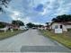 A peaceful street view within the Marbrisa community with sidewalks, landscaping and community signage at 53 W Marbrisa Way, Kissimmee, FL 34743