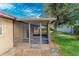 A screened-in back porch featuring an entrance from the home and a large backyard with ample sunlight at 5311 Ansonia Ct, Orlando, FL 32839