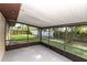 A covered screened-in back porch with a concrete floor offers a seamless transition to the spacious, fenced backyard at 5311 Ansonia Ct, Orlando, FL 32839