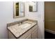 Bathroom featuring granite countertops, a sink, and a mirror, providing a functional space at 5311 Ansonia Ct, Orlando, FL 32839
