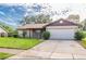 Charming home with a well-maintained front yard, attached garage and covered entry at 5311 Ansonia Ct, Orlando, FL 32839