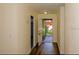 Inviting hallway with wood floors that leads to the front door and other rooms of the home at 5311 Ansonia Ct, Orlando, FL 32839