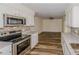 Modern kitchen showcasing granite countertops, stainless appliances, and white cabinets at 5311 Ansonia Ct, Orlando, FL 32839