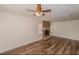 Spacious living room featuring hardwood floors, ceiling fan and a brick fireplace at 5311 Ansonia Ct, Orlando, FL 32839