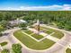 Aerial view of the community clocktower and entrance to the neighborhood surrounded by trees at 5772 Laurel Cherry Ave, Winter Garden, FL 34787