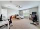 Spacious bedroom with a ceiling fan, large window, and desk perfect for work or study at 5772 Laurel Cherry Ave, Winter Garden, FL 34787