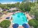 A serene community pool with plenty of seating and shaded areas, perfect for relaxation at 5772 Laurel Cherry Ave, Winter Garden, FL 34787