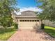 Two car garage with automatic door provides security for your vehicles and toys at 5772 Laurel Cherry Ave, Winter Garden, FL 34787