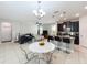 Open-concept kitchen with dark cabinets, granite countertops, and modern stainless steel appliances at 5772 Laurel Cherry Ave, Winter Garden, FL 34787