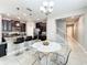 An airy kitchen featuring an eat-in island, modern appliances, and views of the staircase at 5772 Laurel Cherry Ave, Winter Garden, FL 34787