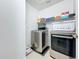 Modern laundry room with front loading stainless steel washer and dryer and ample storage at 5772 Laurel Cherry Ave, Winter Garden, FL 34787