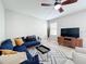 Inviting living room featuring a plush blue sofa, modern furniture, and neutral tones throughout at 5772 Laurel Cherry Ave, Winter Garden, FL 34787