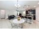 Open-concept living space featuring modern lighting, kitchen island with barstools, and neutral color palette at 5772 Laurel Cherry Ave, Winter Garden, FL 34787