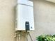Tankless water heater installed on the side of the house for on-demand hot water at 5772 Laurel Cherry Ave, Winter Garden, FL 34787
