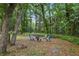 Relaxing backyard fire pit area with comfortable seating nestled amongst mature trees at 628 Riverpark Cir, Longwood, FL 32779