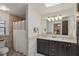 Bathroom featuring a double vanity, granite countertops, and a tiled shower with glass door at 628 Riverpark Cir, Longwood, FL 32779