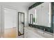 Bathroom featuring dual sinks, white cabinets, and a mirrored vanity at 628 Riverpark Cir, Longwood, FL 32779