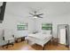 Bright bedroom with hardwood floors, ceiling fan, and two windows for ample natural light at 628 Riverpark Cir, Longwood, FL 32779