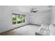 Bedroom featuring neutral carpet, ceiling fan and large windows at 628 Riverpark Cir, Longwood, FL 32779