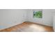 A bright bedroom with hardwood floors, a window, and a neutral color scheme at 628 Riverpark Cir, Longwood, FL 32779