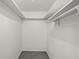 A small walk-in closet with a single hanging rod and storage shelf at 628 Riverpark Cir, Longwood, FL 32779
