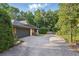 Wide driveway leading to an attached two-car garage and side yard at 628 Riverpark Cir, Longwood, FL 32779