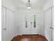 Welcoming foyer with wood floors, a decorative light fixture, and a double door entry at 628 Riverpark Cir, Longwood, FL 32779