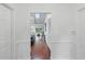 Bright hallway with hardwood floors leading to a living area with a pool view at 628 Riverpark Cir, Longwood, FL 32779