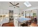 Modern kitchen featuring stainless steel appliances, granite countertops, and a skylight for ample natural light at 628 Riverpark Cir, Longwood, FL 32779