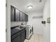 Laundry room with modern washer and dryer, sink and overhead cabinets at 628 Riverpark Cir, Longwood, FL 32779