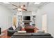 Inviting living room with a brick fireplace, built-in shelves, and ample natural light at 628 Riverpark Cir, Longwood, FL 32779