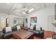 Bright living room with vaulted ceiling, skylights, and comfortable seating, creating an inviting space at 628 Riverpark Cir, Longwood, FL 32779