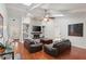 Cozy living room with hardwood floors, a white brick fireplace, and skylights for natural light at 628 Riverpark Cir, Longwood, FL 32779