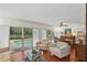 Cozy living room overlooking a private pool, with comfortable seating and abundant natural light at 628 Riverpark Cir, Longwood, FL 32779