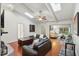 Spacious living room featuring hardwood floors, a brick fireplace, and sliding doors to the patio at 628 Riverpark Cir, Longwood, FL 32779