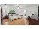 A spacious primary bedroom features hardwood floors, a ceiling fan, and an en-suite bathroom at 628 Riverpark Cir, Longwood, FL 32779