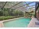 Covered pool area with patio seating, brick trim, and a lovely view of the backyard at 628 Riverpark Cir, Longwood, FL 32779