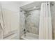 Shower with tiled surround, shower head, shower curtain and towel bar at 628 Riverpark Cir, Longwood, FL 32779