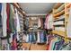 Large walk-in closet with custom shelving, hanging racks, and storage solutions at 628 Riverpark Cir, Longwood, FL 32779