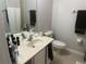 Standard bathroom featuring a mirror, sink, toilet, tile flooring, and towel rack at 6450 Alcalde Ct # 106, Orlando, FL 32835