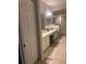 Spacious bathroom with double sinks, tile floors, and glass-enclosed shower stall at 6450 Alcalde Ct # 106, Orlando, FL 32835
