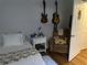 Cozy bedroom featuring a comfortable bed, a sitting chair, and guitars hung on the wall at 6450 Alcalde Ct # 106, Orlando, FL 32835