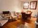 Cozy dining area with a wooden table, upholstered chairs, and modern artwork at 6450 Alcalde Ct # 106, Orlando, FL 32835