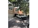 Townhome exterior featuring a white pickup truck parked in the driveway and mature landscaping at 6450 Alcalde Ct # 106, Orlando, FL 32835
