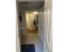 Inviting hallway with tiled flooring, leading to various rooms and complemented by a potted plant at 6450 Alcalde Ct # 106, Orlando, FL 32835