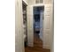 Hallway featuring storage shelves and leading to a bedroom area with neutral walls at 6450 Alcalde Ct # 106, Orlando, FL 32835