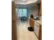 Well-lit kitchen features tile flooring, wood cabinets, and stainless steel appliances at 6450 Alcalde Ct # 106, Orlando, FL 32835